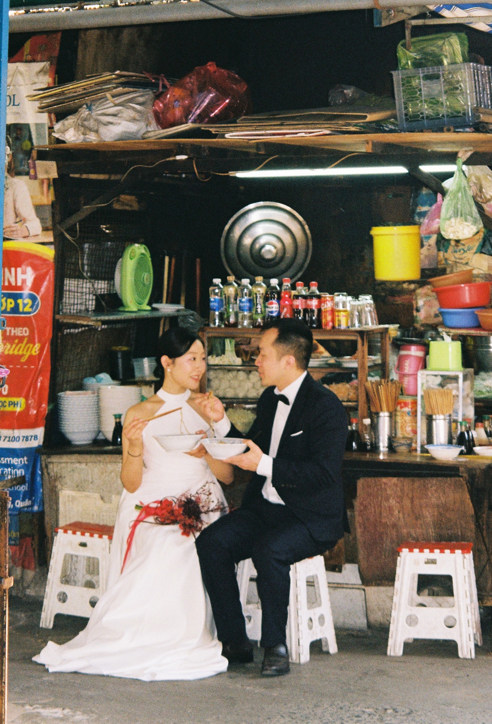 Jessica and Richard sharing a meal on plastic stools